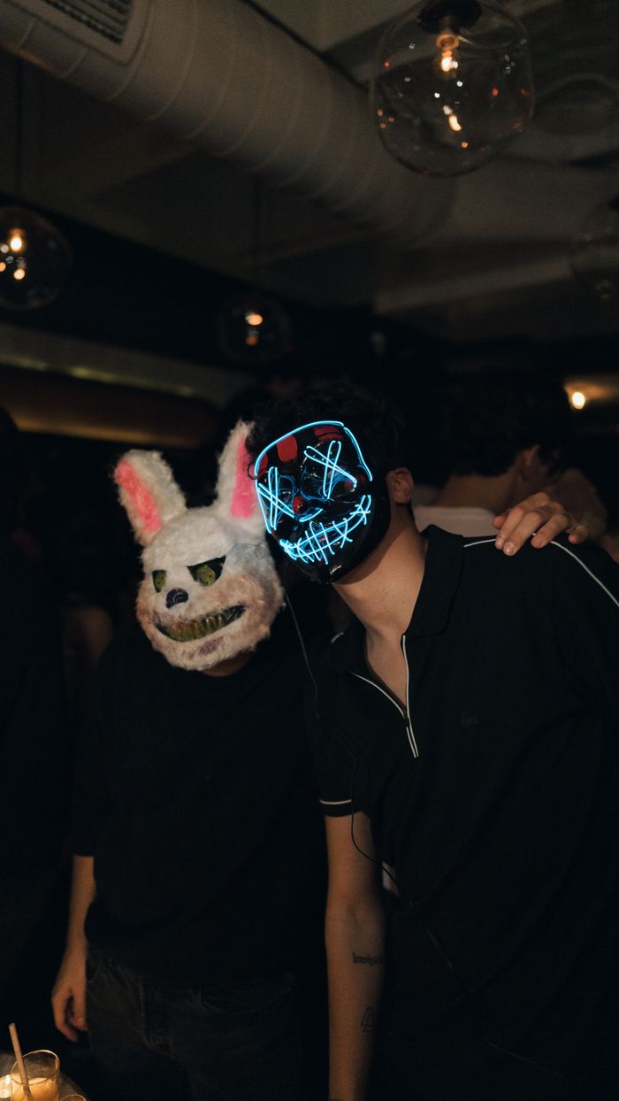 Fun nightclub scene in Istanbul with people wearing neon and animal masks, creating a festive atmosphere.